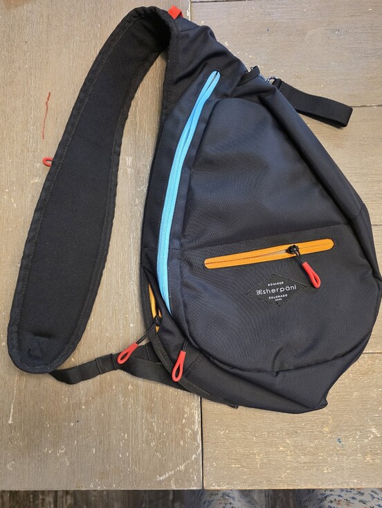 Sherpani Handbags - Sherpani black sling bag with blue and orange accents